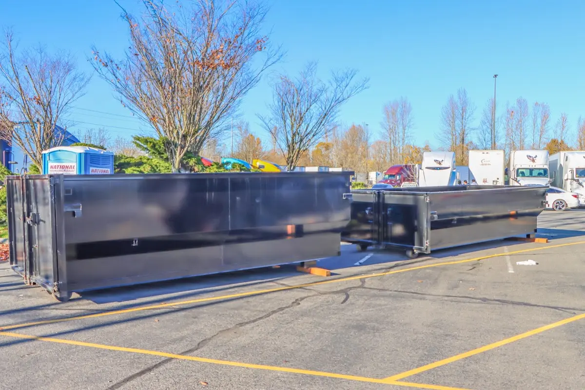 Professional dumpster rental service with roll-off container on residential driveway in Black Forest